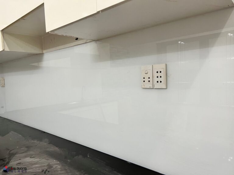 Cận cảnh kính ốp bếp màu trắng đã khoét hai lỗ ổ điện
